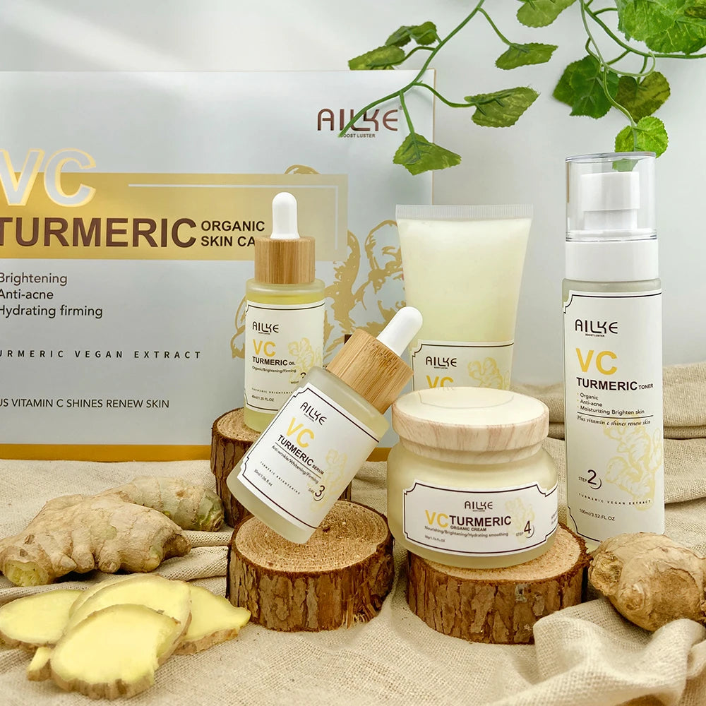 Allue VC Turmeric skincare products on wooden blocks with ginger and a box in the background.
