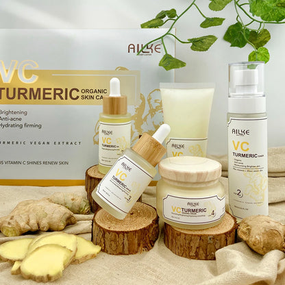 Allue VC Turmeric skincare products on wooden blocks with ginger and a box in the background.