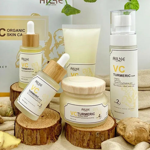 Collection of AILYE VC Turmeric skincare products on wooden blocks with a neutral background.