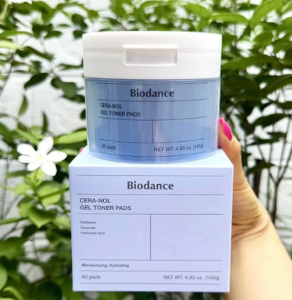 Biodance Cera-Nol Gel Toner Pads packaging held in front of a green leafy background
