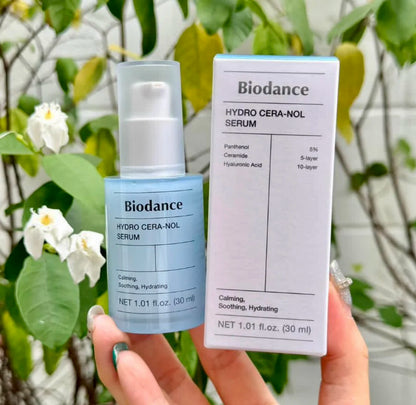Biodance Hydro Cera-Nol Serum bottle and packaging held in front of a leafy background