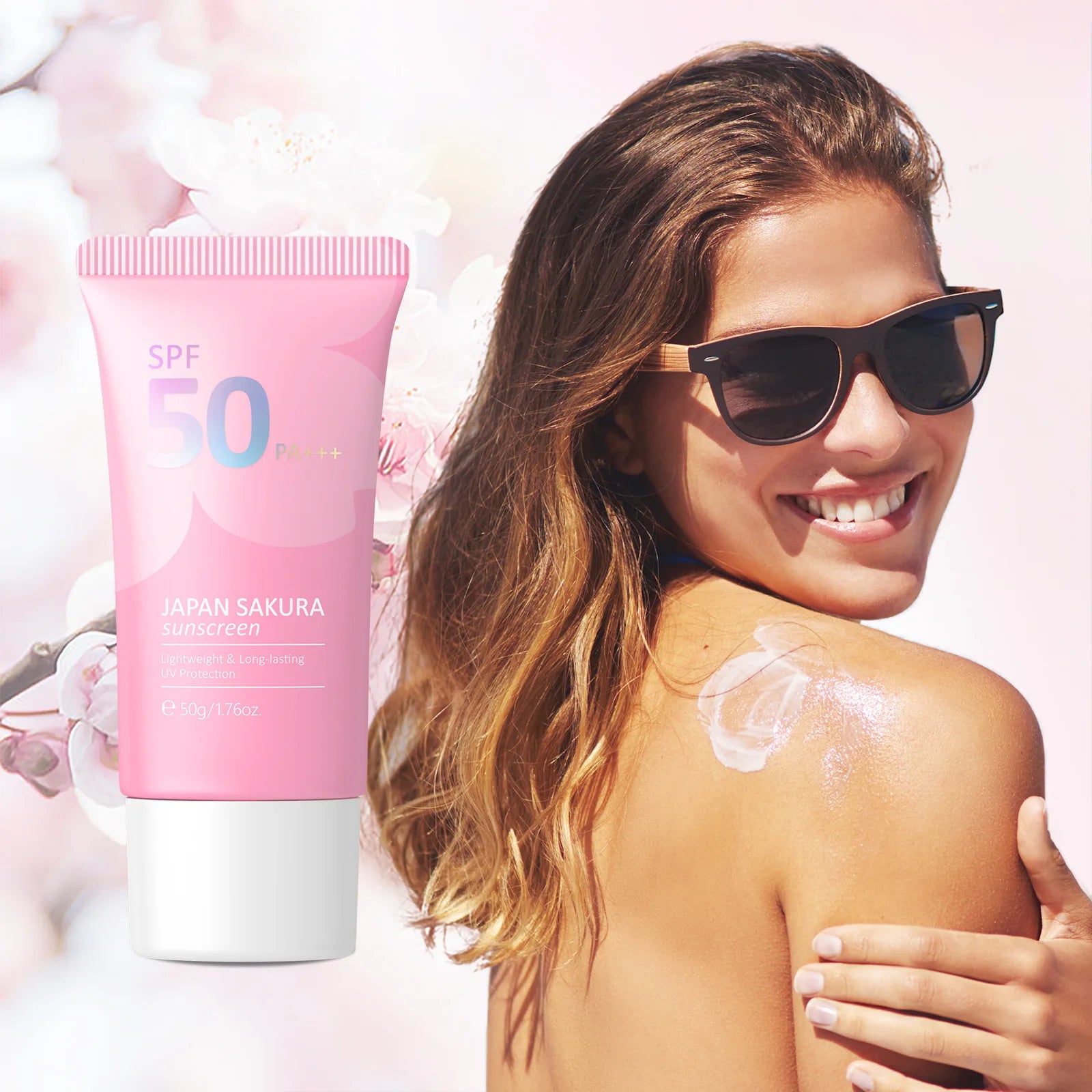 Woman applying sunscreen with a pink SPF 50 sunscreen tube in the foreground